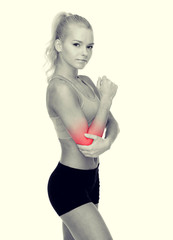 sporty woman with pain in elbow