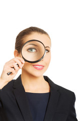 Businesswoman with magnifying glass.