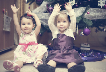 Little girls near the Christmas tree