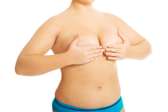 Overweight woman covering breast