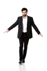 Businessman walking carefully.