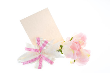Fototapeta na wymiar Single pink rose with some beautiful riboon and card beside, spa