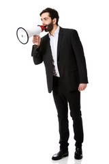 Fototapeta premium Businessman shouting using a megaphone.