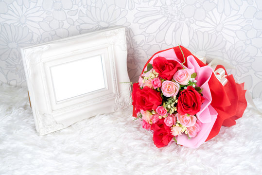 flowers bouquet placed with picture frame
