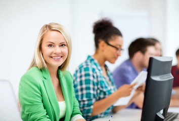 student with computer studying at school
