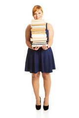 Overweight woman holding books