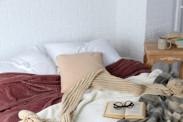 Book and glasses on bed close-up