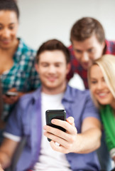 Fototapeta premium students looking at smartphone at school