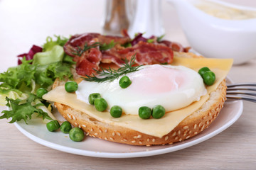 Fototapeta na wymiar Sandwich with poached egg, cheese and bacon