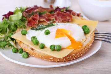 Sandwich with poached egg, cheese and bacon