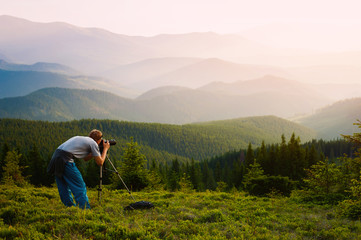 Fototapeta na wymiar Professional photographer journey through the mountains.