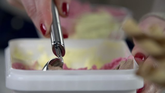 Detail of scooping the ice cream from the package