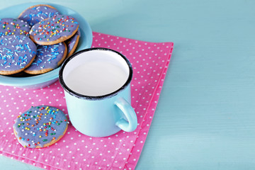 Plate of glazed cookies and mug of milk