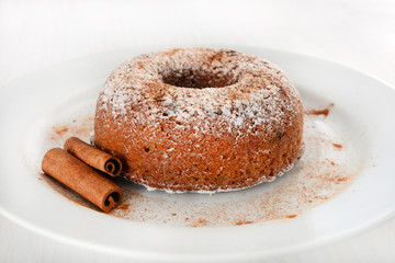 Apple and cinnamon cake with cinnamon sticks around.
