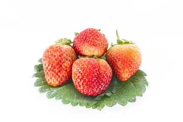 Strawberries and leafs on white background