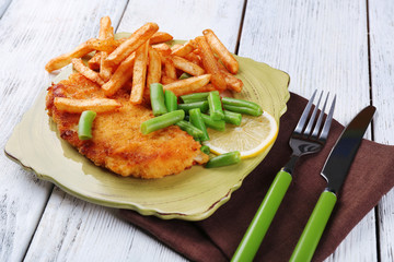 Breaded fried fish fillets and potatoes with asparagus and