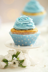 Delicious cupcakes on table on light background
