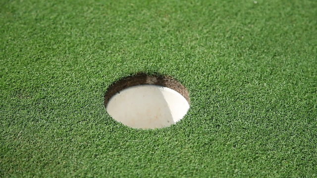 hole and white golf ball