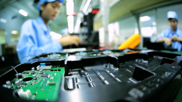 Technology female Chinese worker producing PCBs, China