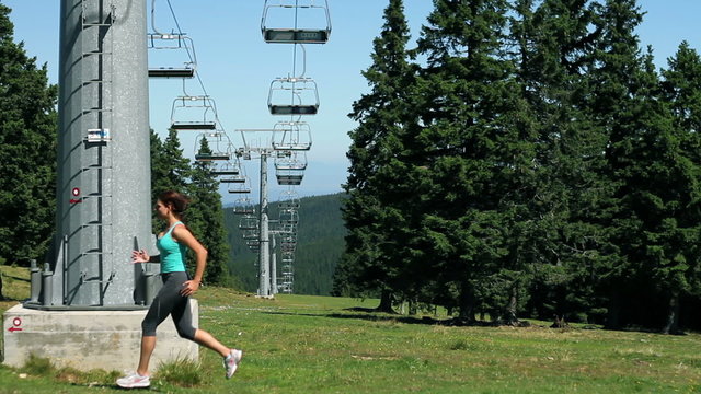 HD1080p: Young woman running under cableway