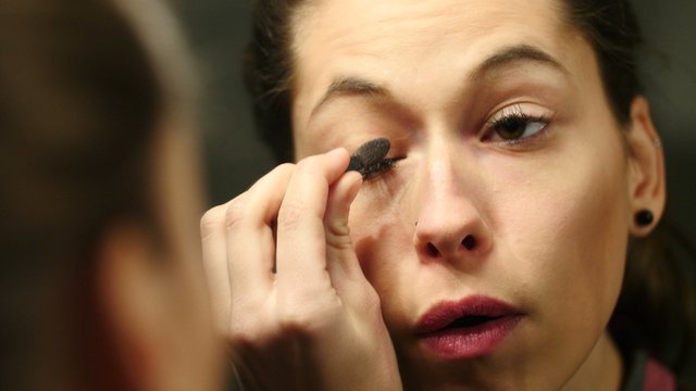 girl in front of the mirror recounts her eyes