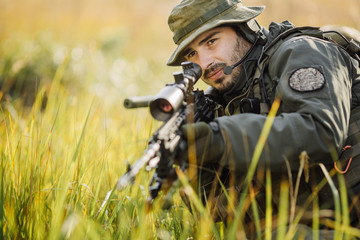 military soldier aiming an assault rifle