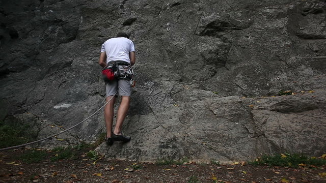 HD1080p: Man preparing for rock climbing