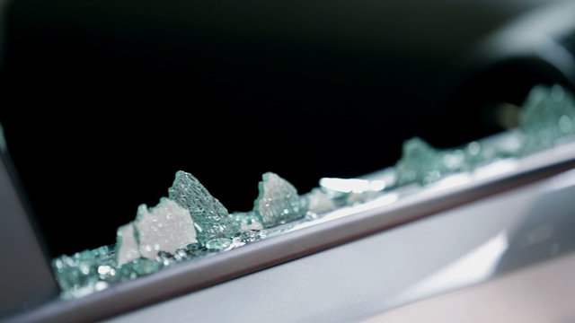 Pieces of glass stayed in the frame of a broken car's side window