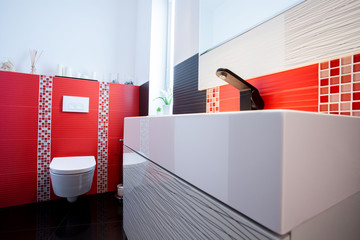 Interior of white and red bathroom