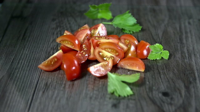 Spice falls onto the tomatoes in slow motion