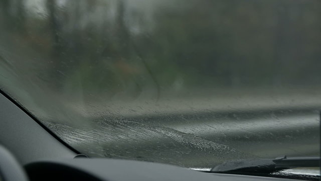 Close shot of left wiper pushing the water off the windscreen