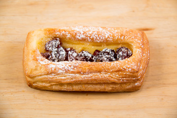 Raisin Danish tasty pastron wood background