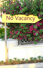 Fototapeta na wymiar Signboard with text No Vacancy near hotel