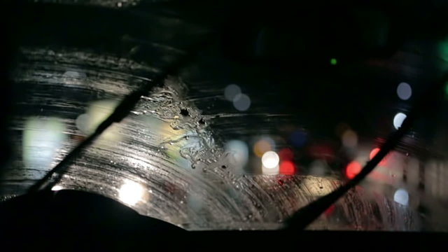 Car windscreen wipers are removing the moistere from the windshield