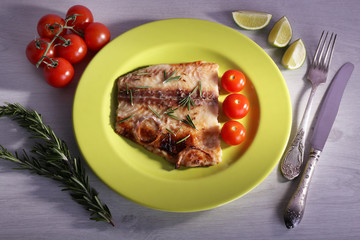 Dish of Pangasius fillet with rosemary and cherry tomatoes in