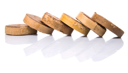 Round palm sugar over white background