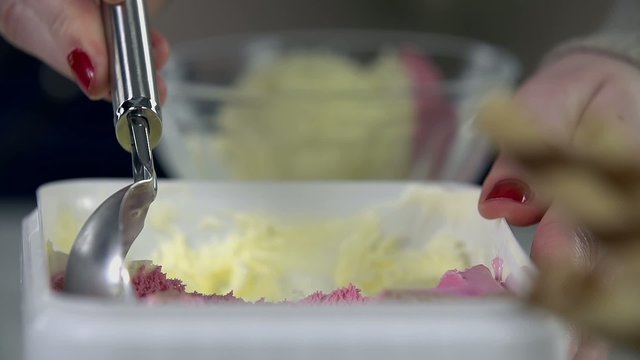 Taking a scoop of ice cream from the box