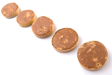 Round palm sugar over white background