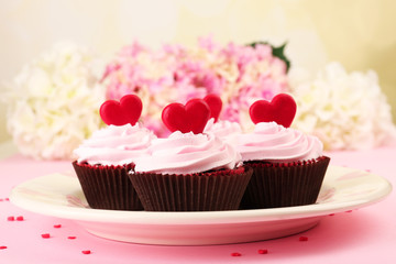 Delicious Valentine Day cupcakes on pink background