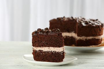 Delicious chocolate cake on table on light background