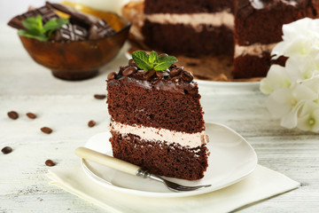 Delicious chocolate cake on table on light background
