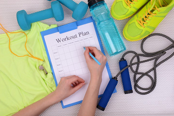 Sports trainer amounts to workout plan close-up
