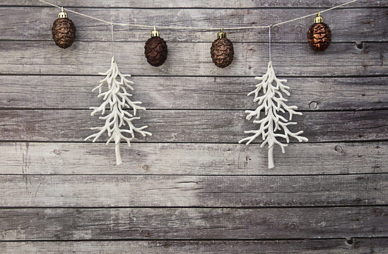 white christmas trees with brown pine cone ornaments