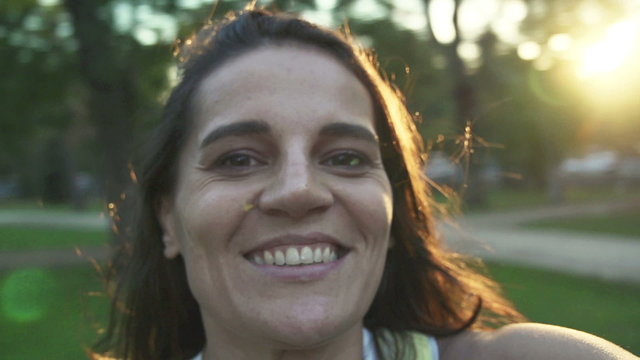 Portrait Of Happy Woman Turning Around In Park