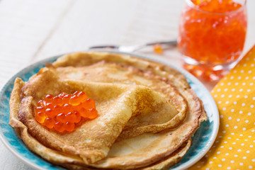 Pancakes with red caviar.