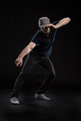 young dancer isolated on black background in studio.
