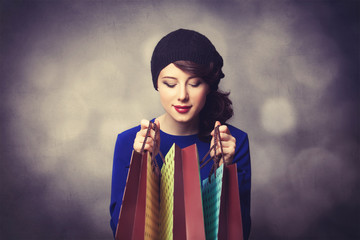 women in blue dress with shopping bags