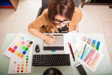 Top view of a graphic designer working in her office