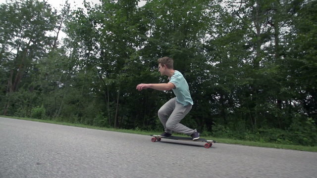 Longboard skating low angle wide slow motion