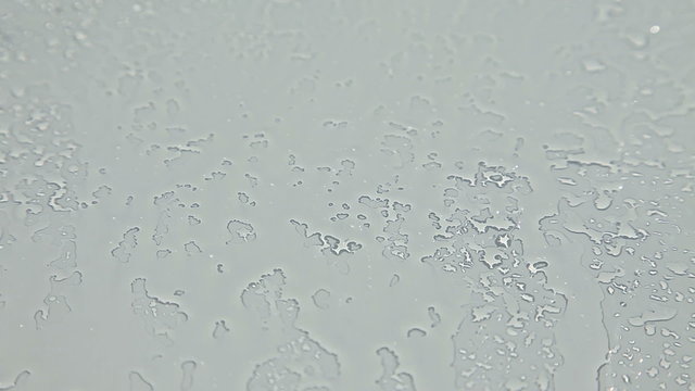 Spraying water on windshield glass